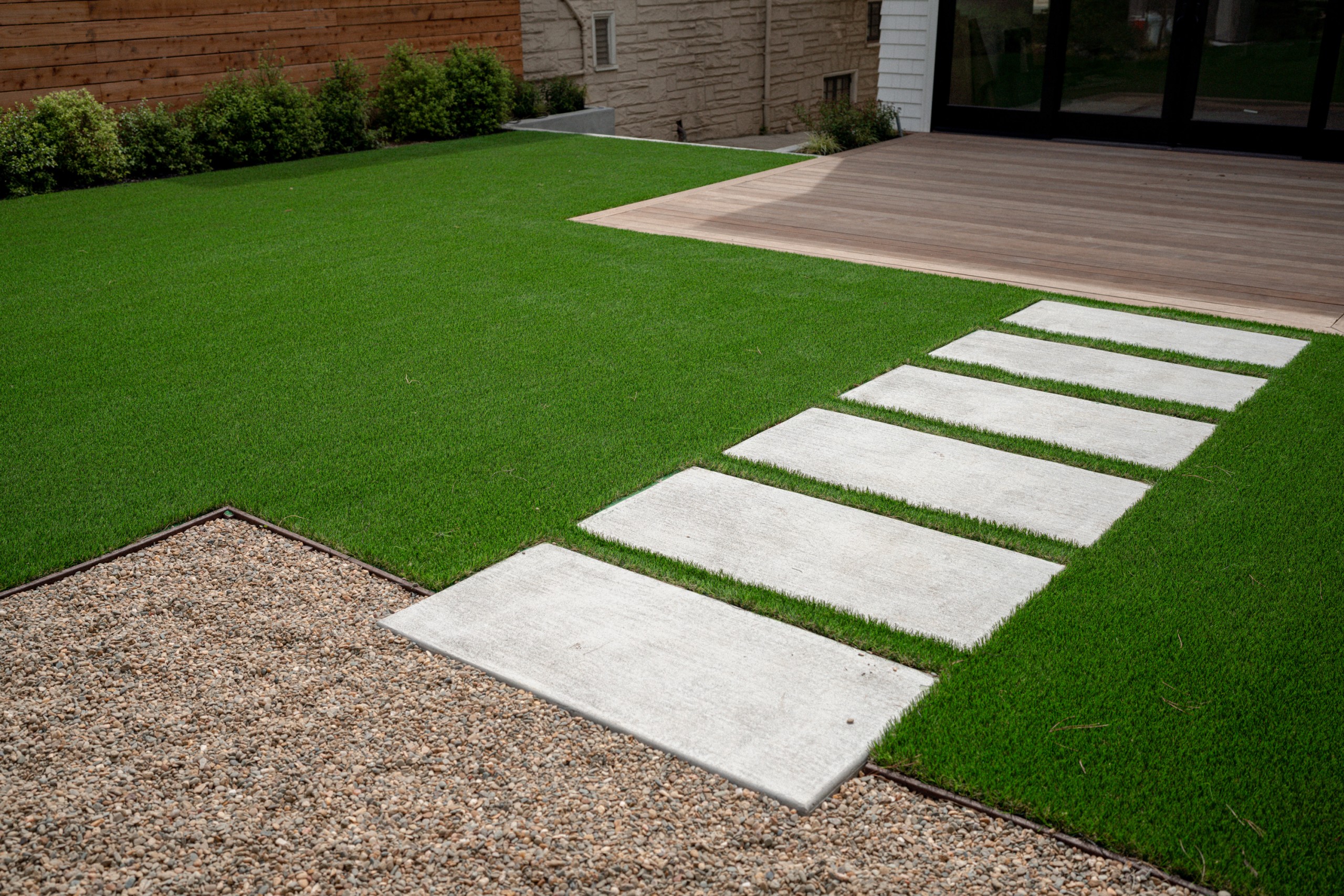 Backyard showing stepping stones and turf