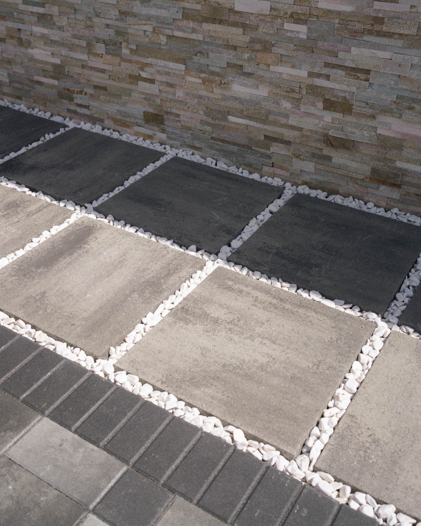 Photo of gray pavers with white pebbles interlaying