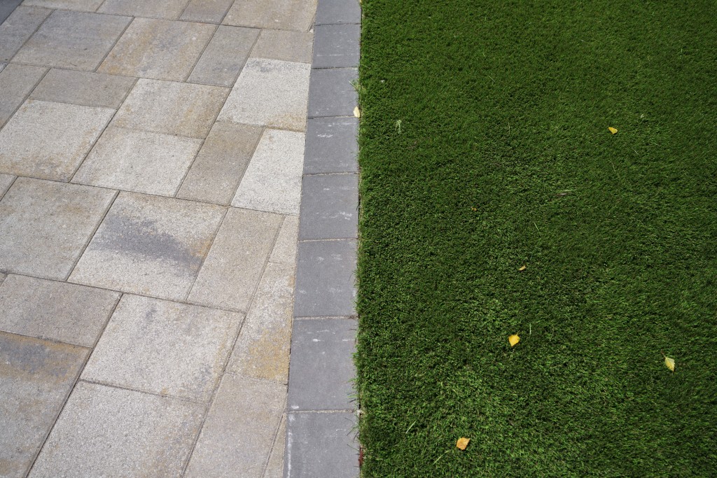 Photo of brown pavers with dark grey border in sailor, or horizontal, pattern