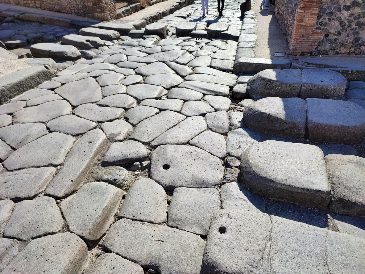 Photo of ancient paver stone path laid in rome