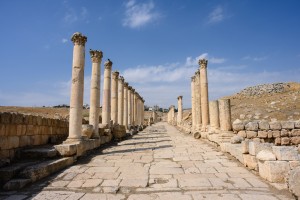 Photo of Roman ruins, a paver path walks between ancient columns